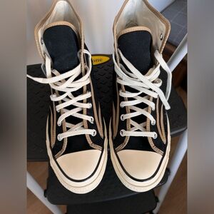 Black canvas with tan faux leather trim All Star high tops.